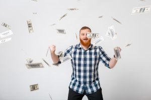 A man excited with cash in the air